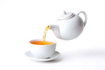 White teapot pouring tea into white cup isolated on white background