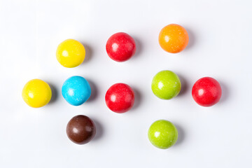 Top view of colorful chocolate coated candy isolated on white background