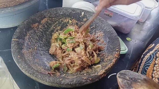 Bekasi, West Java, May 2, 2025 - The process of making KAREDOK, a typical Indonesian Sundanese food that is often found by sellers on the side of the highway.