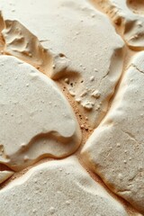 Delicate patterns emerge from the golden crust of freshly baked meringue, showcasing nature's artistry in a kitchen setting