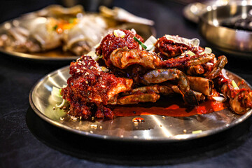 Yangnyeom Gejang – Korean Spicy Marinated Raw Crab with Sesame and Scallions. Close-up of Yangnyeom Gejang, a bold Korean dish of raw crab marinated in spicy red chili paste (gochugaru).