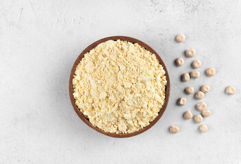Lupine flour in a wooden bowl on a white background. Gluten-free, protein-rich food. Top view.