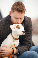 Handsome young man spending time with his dog
