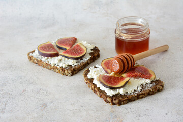 some Toasts with Ricotta Cheese and slices of fig and honey