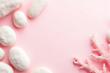 Minimalistic layout of pink and white coral surrounded by polished beach stones over light neutral background