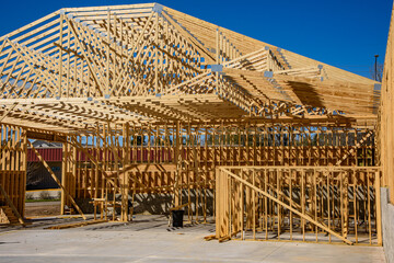 Network of wood framing members for wood frame commercial building under construction.