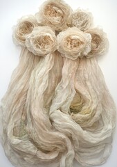 Delicate, flowing fabric draped, accented with clustered, light beige rose-like blossoms.  Soft, pastel tones and flowing lines create a gentle, airy aesthetic