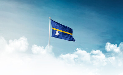 Nauru national flag with mast waving in beautiful sky. Nauru flag for Republic Day and Independence...