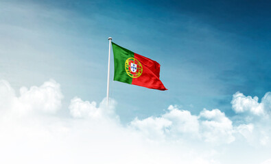 Portugal national flag with mast waving in beautiful sky. Portugal flag for Republic Day and Independence Day.