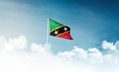 Saint Kitts and Nevis national flag with mast waving in beautiful sky. Saint Kitts and Nevis flag...