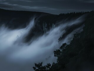 Misty mountain peaks shrouded in twilight.