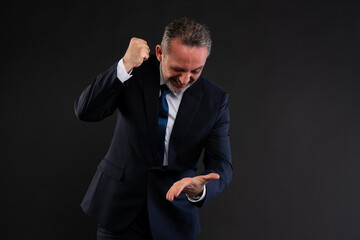 Frustrated businessman hitting palm with fist.