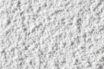 Obraz premium Close-up of fine, white powder. A textured surface of small, uneven particles