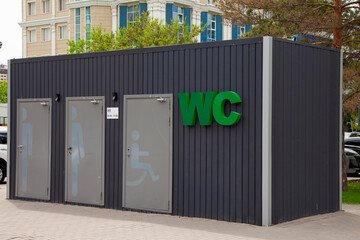 Outdoor toilet cubicles marked WC