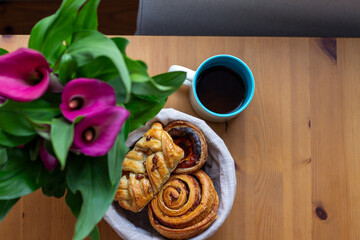 An aromatic symphony of pastries beside vibrant calla lilies, perfect for Hygge moments and Danish Fastelavn indulgence
