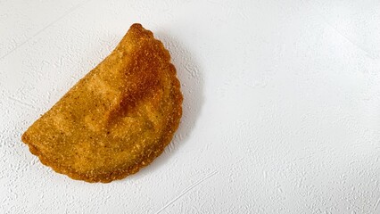 Crispy golden empanada whispers tales of Hispanic culinary rituals, serenading Dia de los Muertos and savory crescent dreams