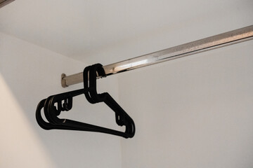 Black plastic clothes hanger in a wardrobe a simple wardrobe