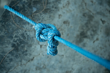 The knotted rope and its stark background make this a versatile visual metaphor for emotional connection, conflict resolution, or infrastructure and reliability.