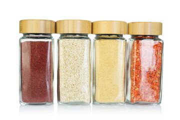 Many different aromatic spices in jars isolated on white
