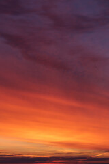 Dramatic soft sunrise, sunset red violet orange sky with clouds and yellow sunlight abstract background texture