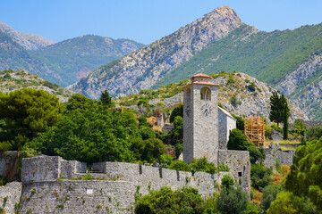 Fototapeta premium Clock tower of Stari grad Bar (Old Town of Bar), the ruins of an ancient walled city at the foot of Mount Rumija in Montenegro