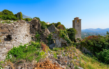 Fototapeta premium Clock tower of Stari grad Bar (Old Town of Bar), the ruins of an ancient walled city at the foot of Mount Rumija in Montenegro