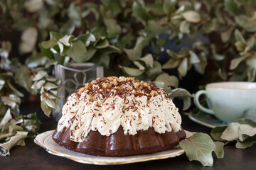 Homemade chocolate cake with whipped cream and walnuts