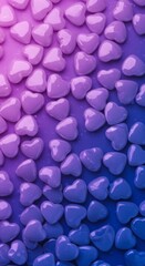 Many heart shaped candies arranged on blue and purple background creating sweet abstract dessert concept for Valentine's Day or romantic holiday celebration