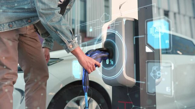 Handsome Caucasian male plugging charging cable into electric station. Glowing holographic numbers of charging battery rapidly increasing. AI integration. Advanced electric vehicle technology.