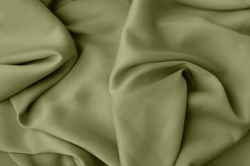 Obraz premium Elegant fabric texture in green color with soft flowing folds and creases