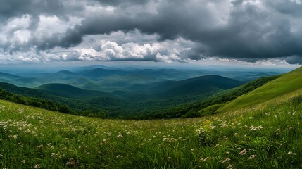Fototapeta premium Vast mountain vista under dramatic sky.