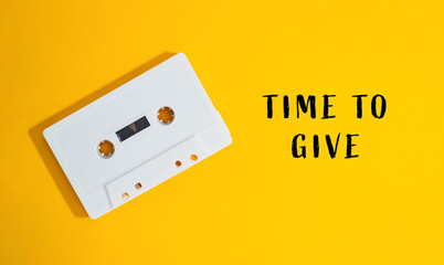White cassette tape with the words time to give written on it