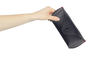 glasses case in hand, outstretched hand with leather glasses case, isolated from background