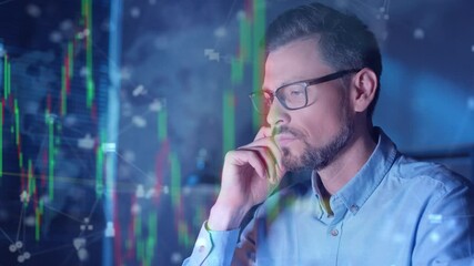 Focused bearded male in glasses resting chin on hand while glowing stock market charts floating in air around. Digital financial data surrounding figure. Investment analysis. Making buying decision. - Powered by Adobe