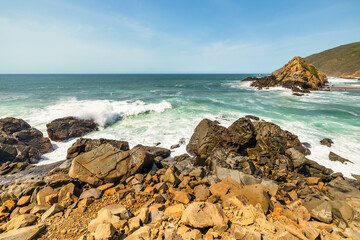 Breathtaking view of Pfeiffer Beach in Big Sur, California, featuring its iconic rock arch, golden sand, and turquoise waves. A stunning coastal landscape perfect for travel and nature lovers