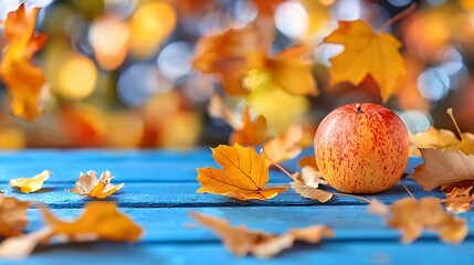 Apple and Autumn Leaves on a Blue Wooden Table