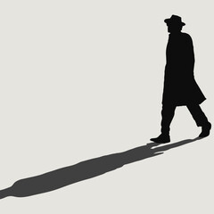 Silhouette of Man in Hat and Coat Casting Long Shadow