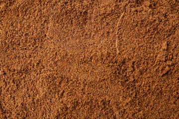 Superfood. Nutmeg powder as background, top view