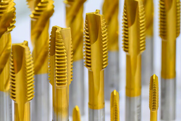 Close up scene the golden coating tap tool for CNC machine.