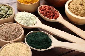 Different superfood products on wooden table, closeup