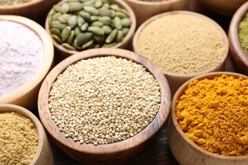 Different superfoods in bowls on table, closeup