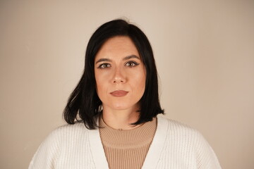 The picture shows a woman with dark hair. Close-up portrait of a young woman in a gray T-shirt on a...