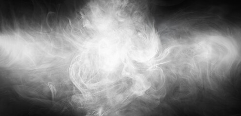 Abstract smoke texture over black background. Fog in the darkness.