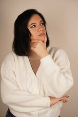 A calm pose, symbolizing mindfulness and reflection. A young woman places her hand under her chin,...