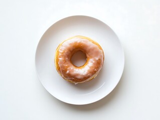 Glazed donut on a round white plate with a hole in center resting on white surface