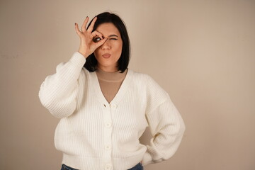 A woman playfully makes an 