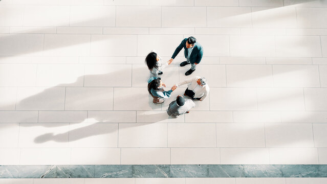 Handshake, greeting and business people in office from top view for introduction, welcome or agreement. Collaboration, partnership and financial managers with stakeholder for investment deal together