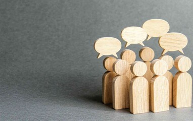Wooden figures, representing people, stand clustered together, with speech bubbles above them, indicating communication and discussion