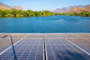 Solar panels installed on the surface of the lake with mountain background.