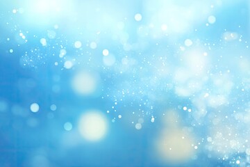 Light blue bokeh background with glittering particles